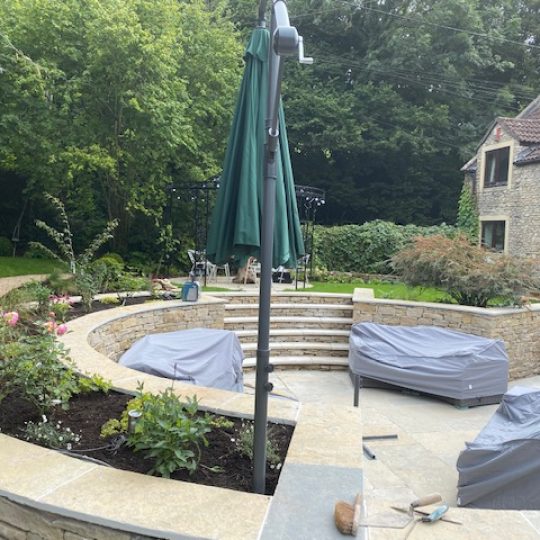 Unbrella Cotswold stone garden Umbrella outside in Cotswold stone garden